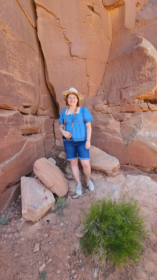 Carly in front of ancient petroglyphs